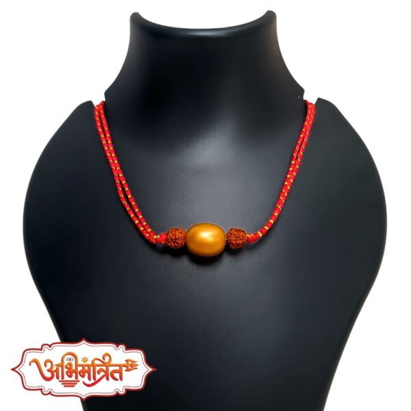 Swarnakarshan Bhairav Abhimantrit Swarn Gutika with Rudraksha and red thread for wealth, protection, and prosperity